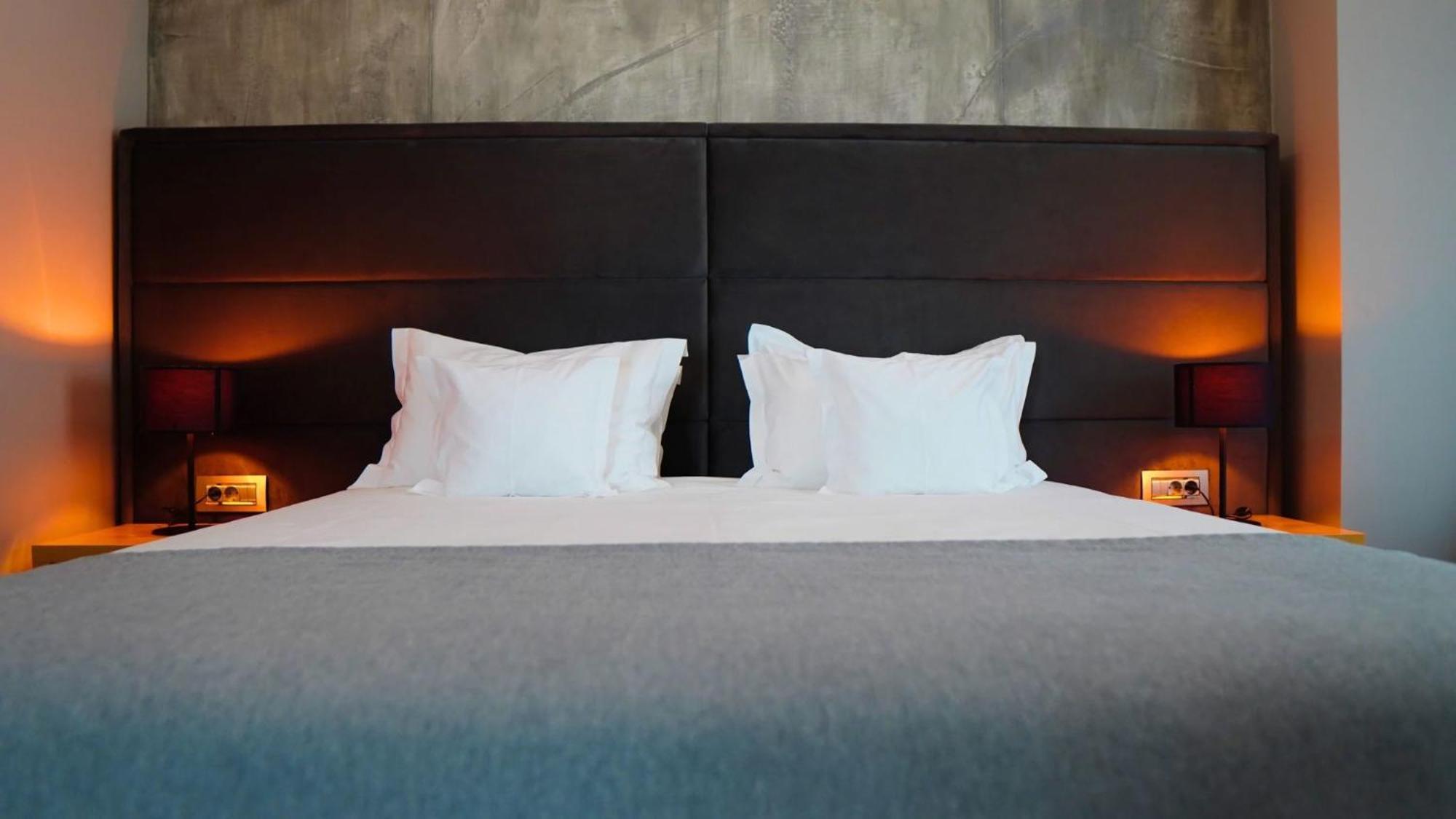 Aniroc Signature Hotel Arad Bagian luar foto A bed with two pillows